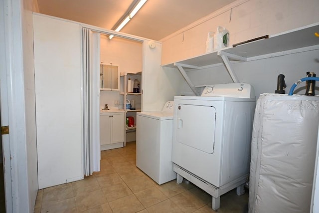 washroom featuring separate washer and dryer, light tile floors, and water heater