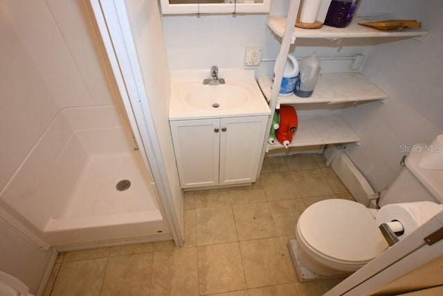 bathroom with toilet, tile floors, and vanity