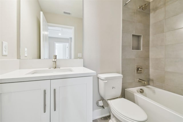 full bathroom featuring vanity, toilet, and tiled shower / bath combo