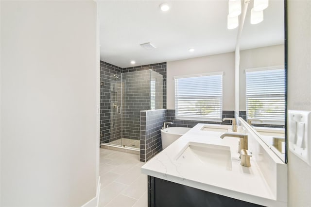 bathroom with tile patterned floors, independent shower and bath, and vanity