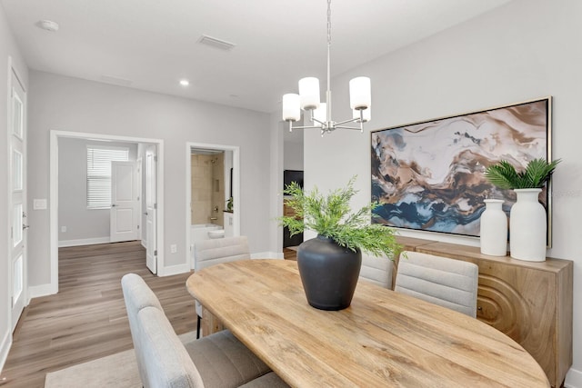 dining room with an inviting chandelier and hardwood / wood-style floors