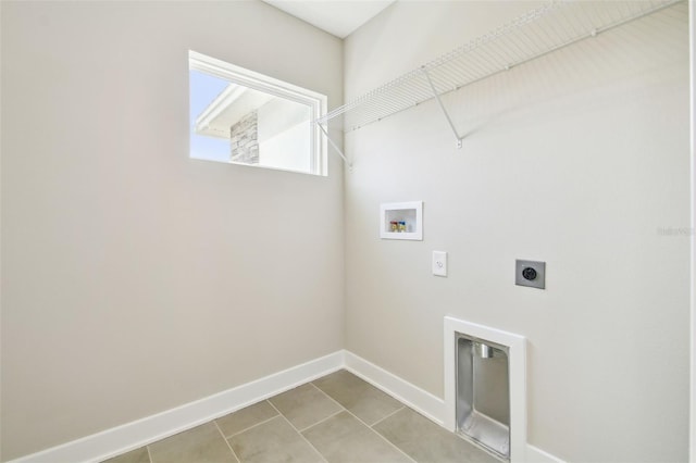 laundry area featuring electric dryer hookup, washer hookup, and light tile patterned flooring