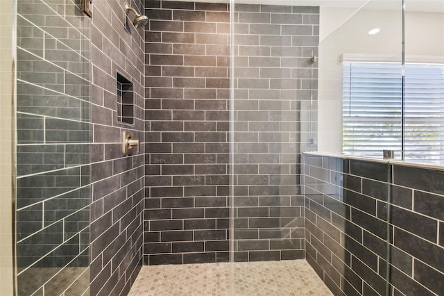 bathroom with a tile shower