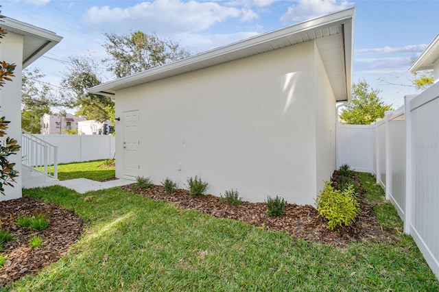 view of side of home with a lawn