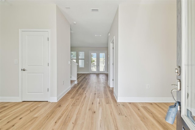 foyer featuring light hardwood / wood-style flooring and french doors