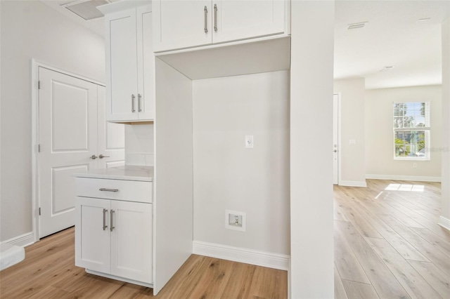 kitchen featuring white cabinets and light hardwood / wood-style floors