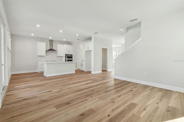 unfurnished living room featuring light hardwood / wood-style flooring