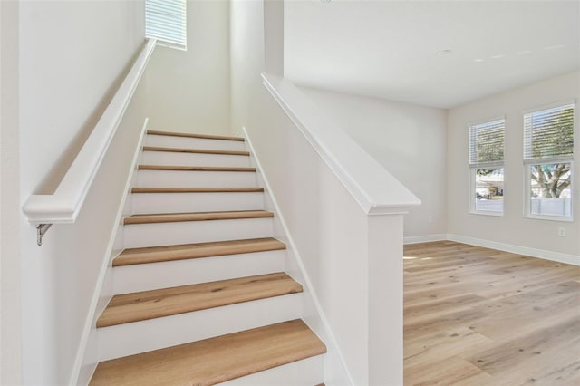 stairs featuring hardwood / wood-style flooring