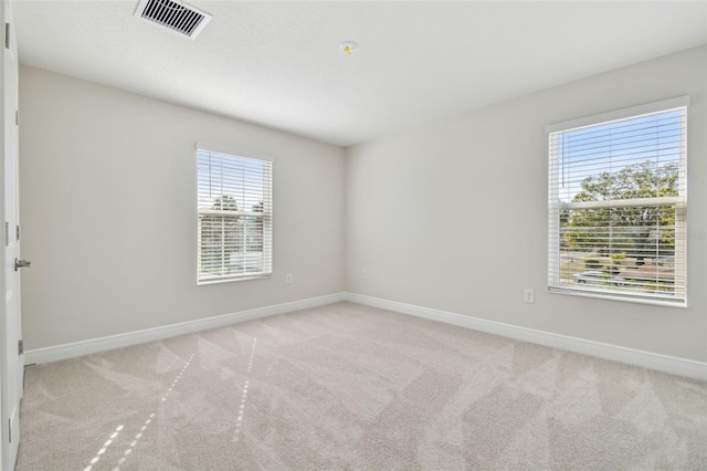 unfurnished room with light carpet