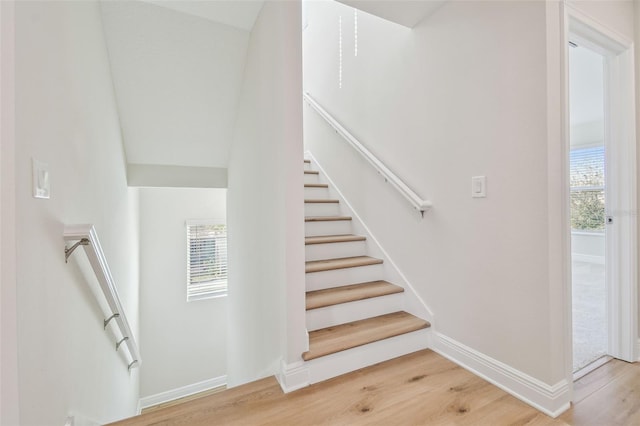 stairway featuring wood-type flooring