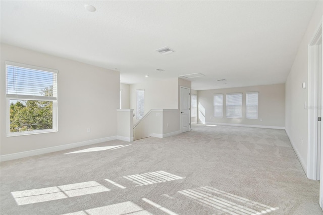 spare room featuring light colored carpet