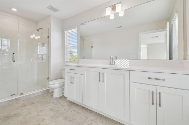 bathroom featuring toilet, vanity, and an enclosed shower