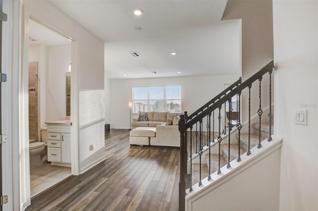 stairs featuring dark wood-type flooring