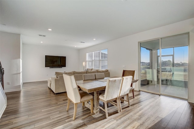 dining space with a wealth of natural light and light wood-type flooring