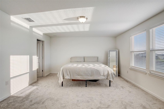 bedroom with light colored carpet