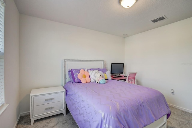 carpeted bedroom featuring a textured ceiling