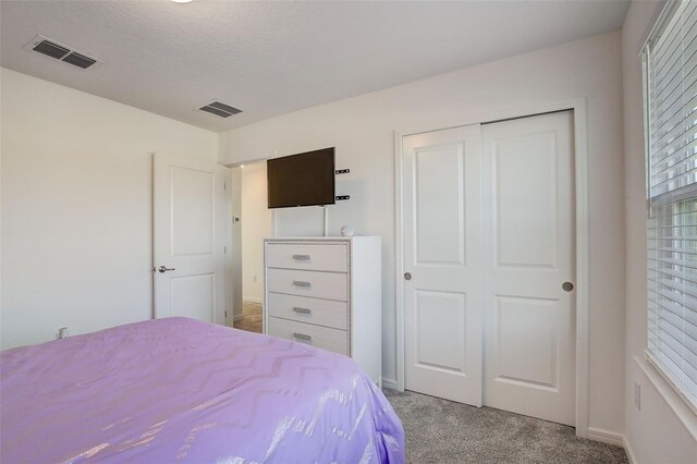 carpeted bedroom featuring a closet