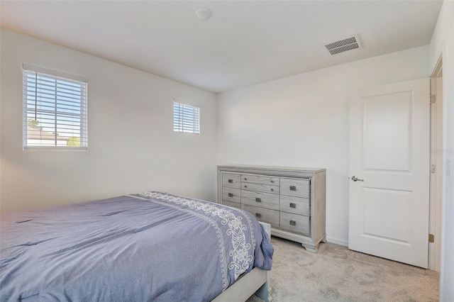 bedroom with light colored carpet