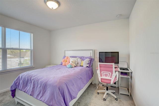 bedroom featuring light carpet