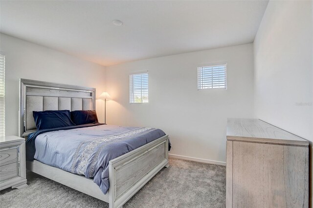 bedroom with light colored carpet