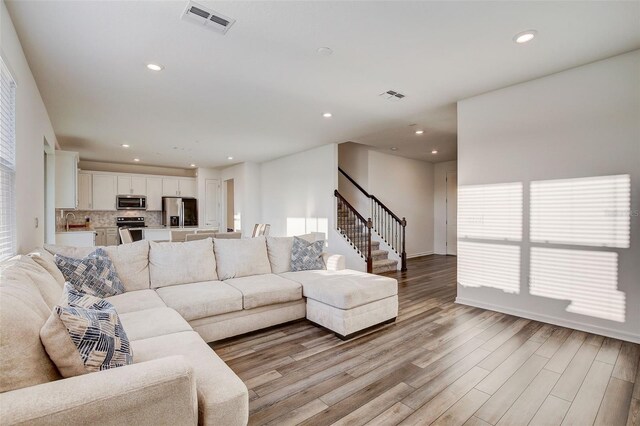 living room with light hardwood / wood-style floors and a wealth of natural light