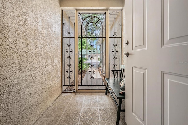 doorway to outside featuring tile floors