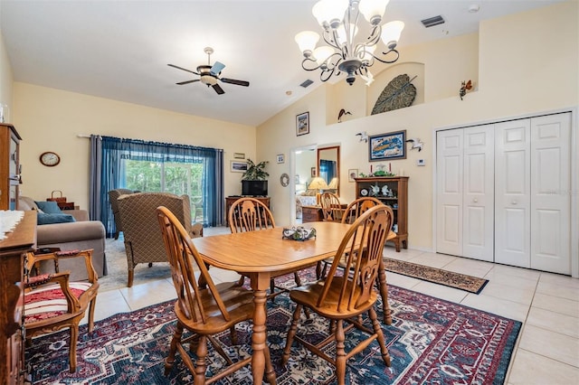 dining area featuring vaulted ceiling, light tile floors, and ceiling fan with notable chandelier