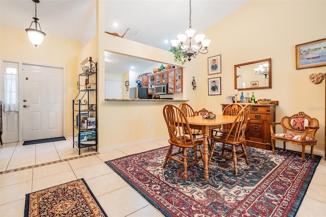 tiled dining room with an inviting chandelier and high vaulted ceiling