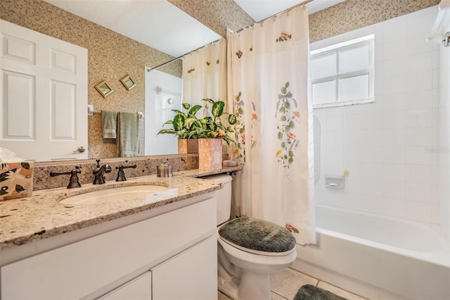 full bathroom with toilet, tile floors, shower / bathtub combination with curtain, and vanity with extensive cabinet space