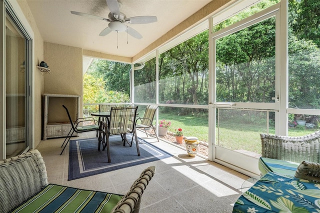 sunroom / solarium featuring ceiling fan