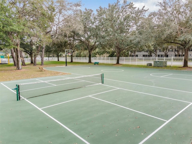 view of tennis court featuring basketball hoop