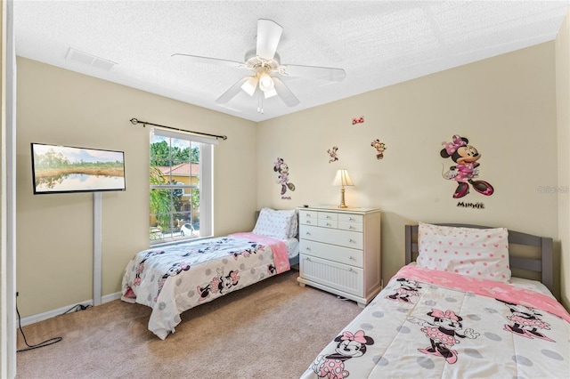 bedroom featuring a textured ceiling, ceiling fan, and light colored carpet