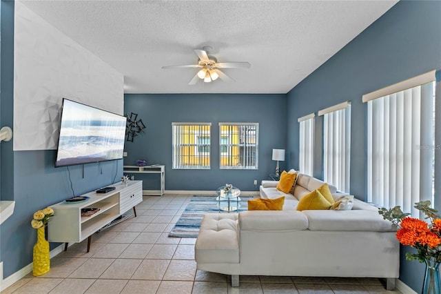 tiled living room with ceiling fan and a textured ceiling