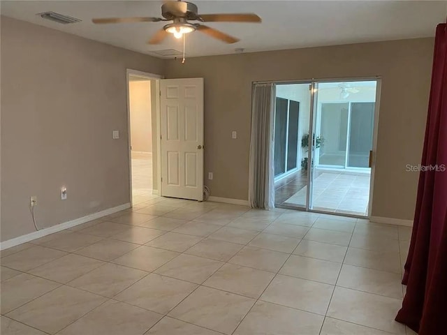 empty room featuring ceiling fan and light tile floors