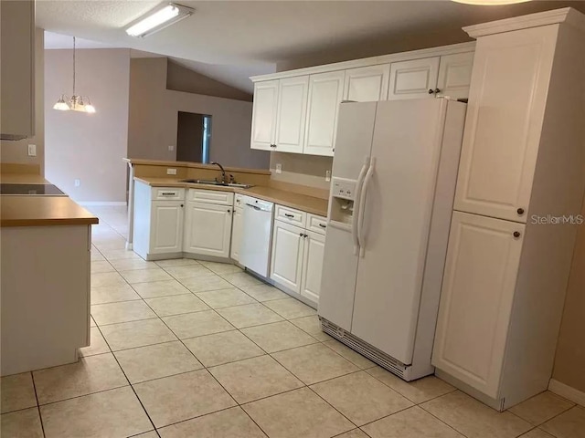 kitchen with an inviting chandelier, white appliances, light tile flooring, and white cabinetry