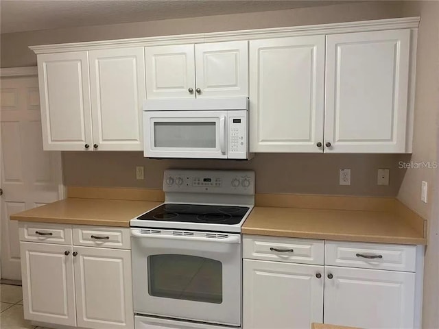 kitchen featuring white appliances and white cabinetry