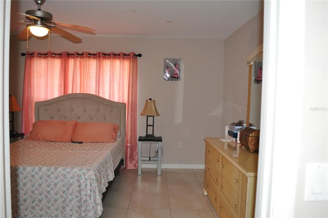 tiled bedroom featuring ceiling fan