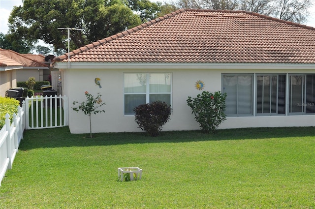 view of home's exterior with a lawn