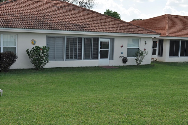 rear view of house with a yard