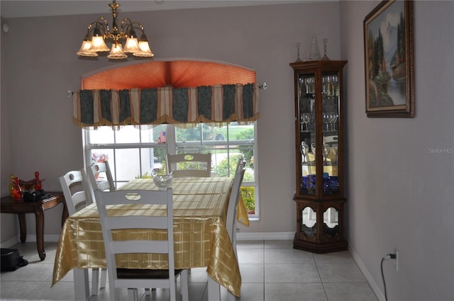 dining space with a chandelier and light tile flooring