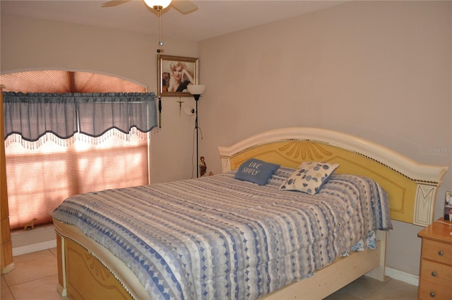 bedroom featuring ceiling fan and light tile floors