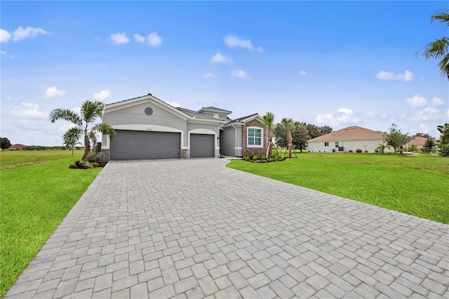 view of front of house featuring a front lawn and a garage