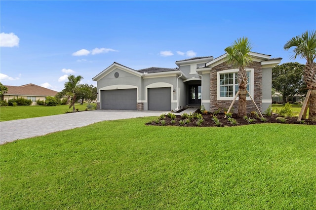 view of front of home with a front lawn and a garage