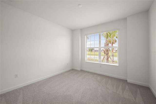 unfurnished room featuring light colored carpet