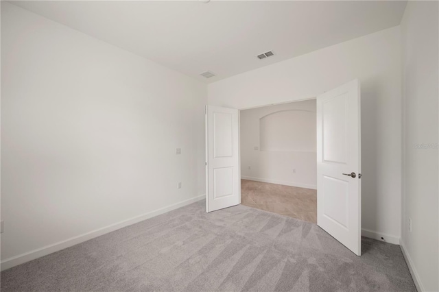 unfurnished bedroom with light colored carpet