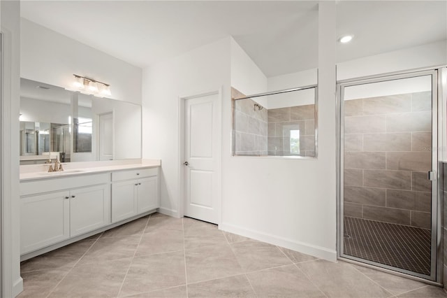 bathroom featuring tile floors, an enclosed shower, and vanity