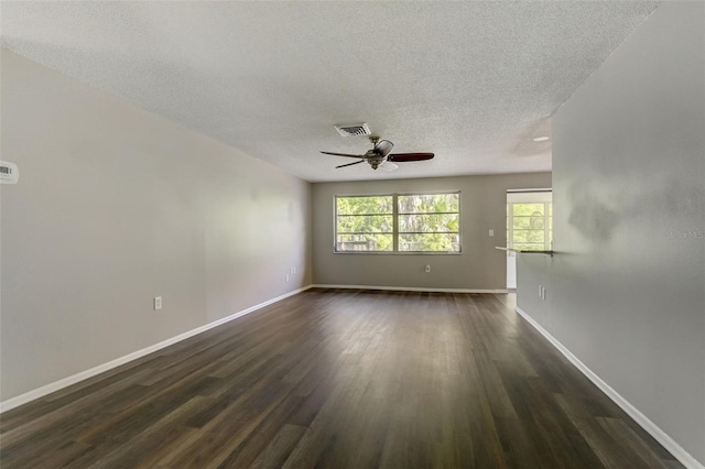 spare room with ceiling fan, a textured ceiling, and dark hardwood / wood-style flooring