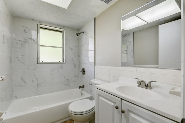 full bathroom featuring vanity, tiled shower / bath combo, tile walls, toilet, and tasteful backsplash