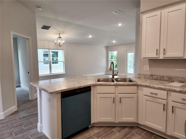 kitchen featuring pendant lighting, sink, stainless steel dishwasher, an inviting chandelier, and white cabinetry