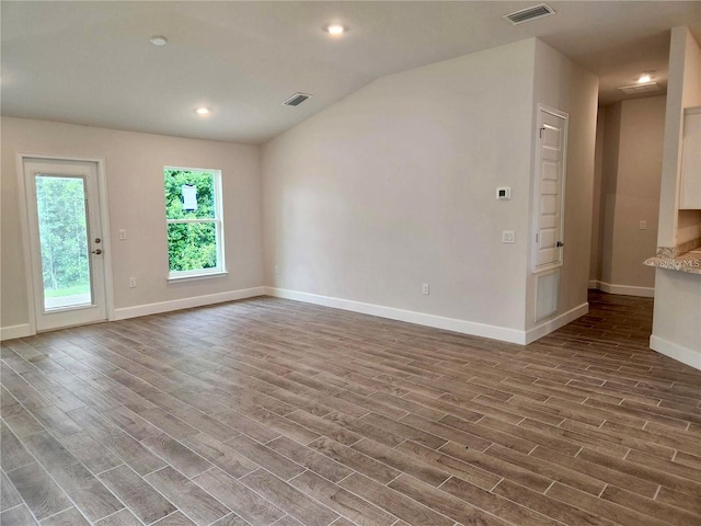 unfurnished room with lofted ceiling and dark hardwood / wood-style flooring